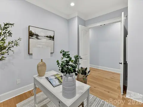 Dedicated main-level office provides a bright and quiet workspace with large windows, recessed lighting, and plenty of room for working from home.