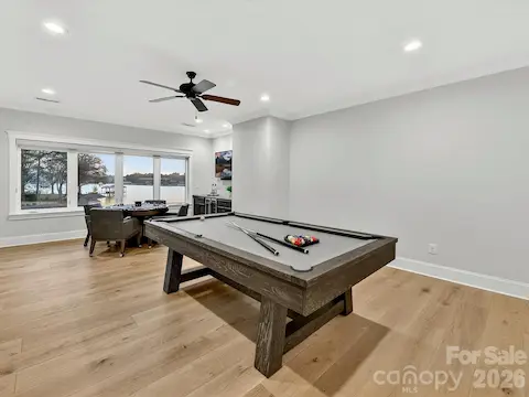 Spacious second-floor recreation room offers the perfect setting for billiards, games, entertaining, or relaxing while enjoying scenic lake views.