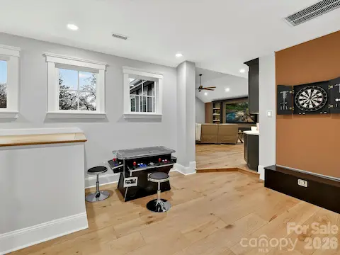 Dedicated game room provides the perfect space for arcade games, basketball, and endless entertainment for family and guests.