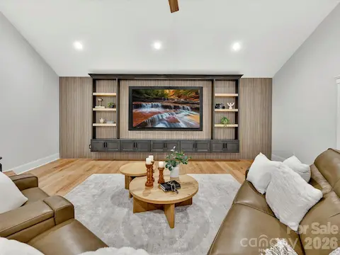 Expansive bonus room showcases a custom built-in media wall, vaulted ceiling, and flexible space ideal for movie nights, gaming, or gathering with family and friends.