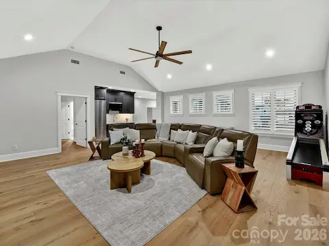 Expansive bonus room showcases a custom built-in media wall, vaulted ceiling, and flexible space ideal for movie nights, gaming, or gathering with family and friends.