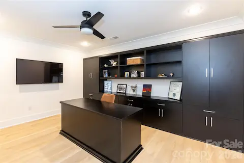 Office located in basement with built in storage and desk