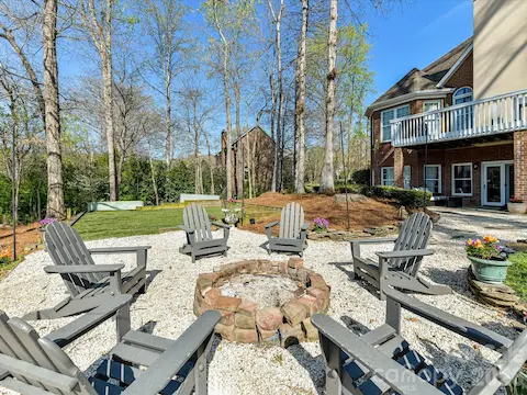 Large fire pit area in the backyard is perfect for entertaining and enjoying the beautiful weather