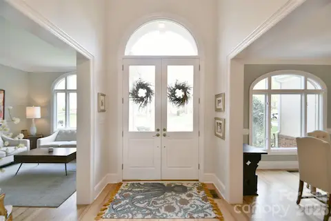 Enter to a light-filled two-story foyer