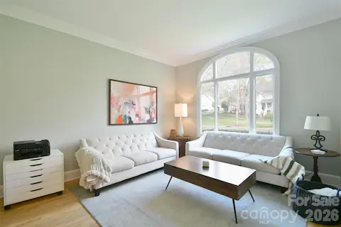 Beautiful Living Room with arched window and crown molding