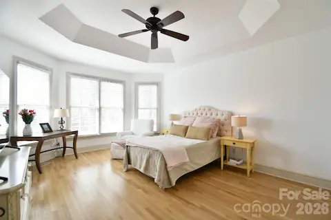 Serene primary bedroom on the main level with bay windows and trey ceiling