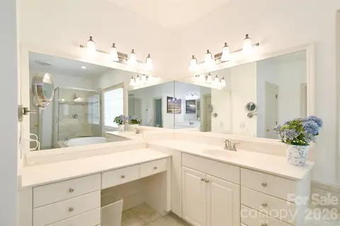 Primary bathroom has dual vanities and a make-up area