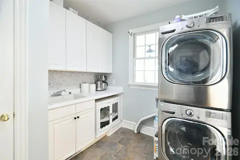Large laundry room with sink and cabinetry