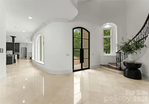 Three Story Entry Foyer with Marble Flooring and Curved Walls