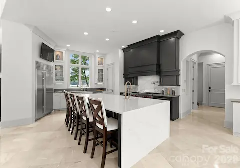 Gourmet Kitchen with Waterfall Quartz Island & Subzero Refrigerator