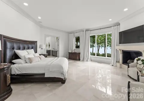 Main Level Primary Suite with Fireplace and views of the lake