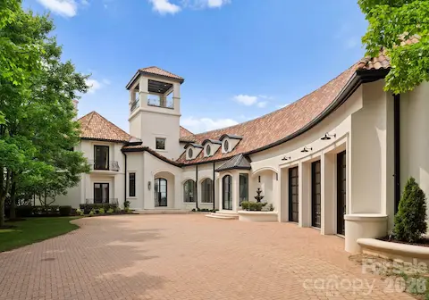 Large, brick driveway entrance past the gate
