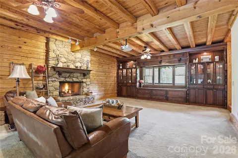 Great room with built-in, large drop down screen and projector, with gas fireplace.
