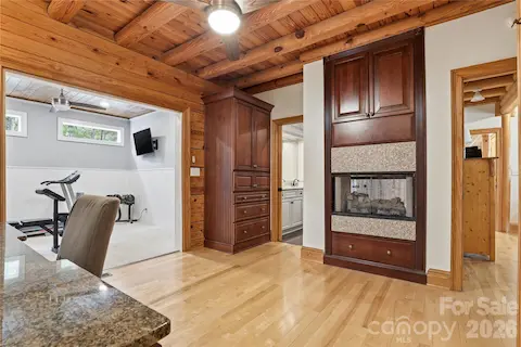 Changing room, workout room, see-through fireplace to shower in primary bathroom.