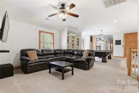 Living / Flex / Game Room with built-in wet bar, and door to large deck over looking pool.