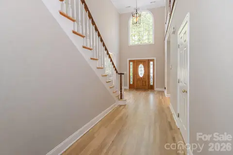 Foyer with beautiful hardwood floors and high ceilings