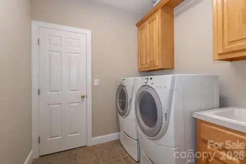 Laundry room is accessible from one of the primary bedroom closets