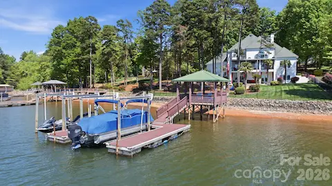 Dock with covered lounge area and two boat lifts.