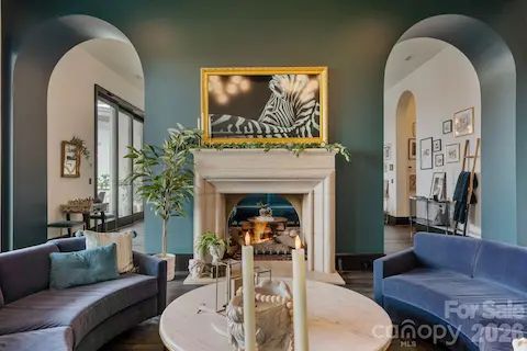 Two-sided gas fireplace between the lounge and living room.