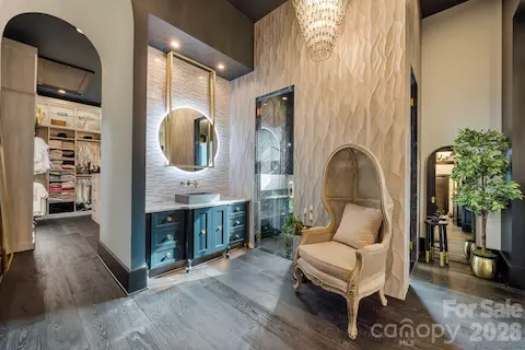 Beautiful primary bathroom with separate vanities, and steam shower.