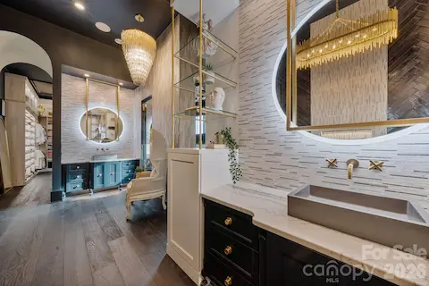 Primary bathroom with dual vanities.