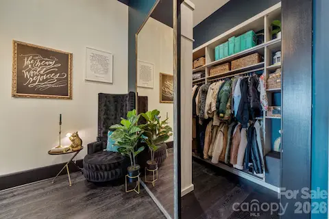Oversized coat & storage closet, revealed behind sliding mirror door.