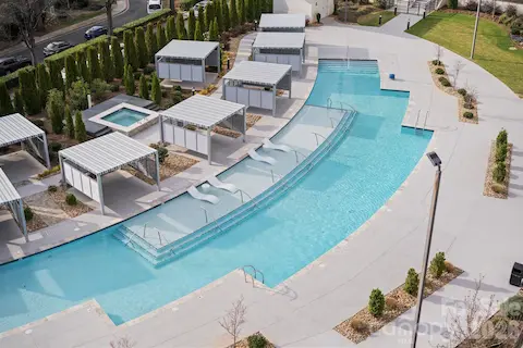 Resort-style pool and hot tub with cabanas.