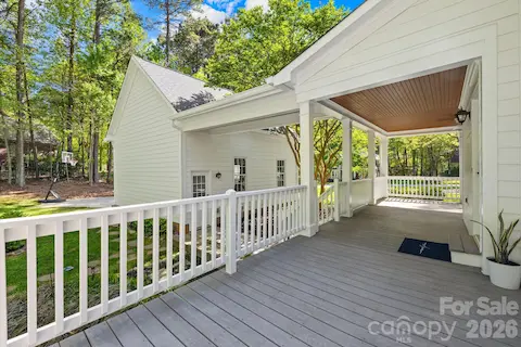 Side deck/porch with covered walkway to the garage.