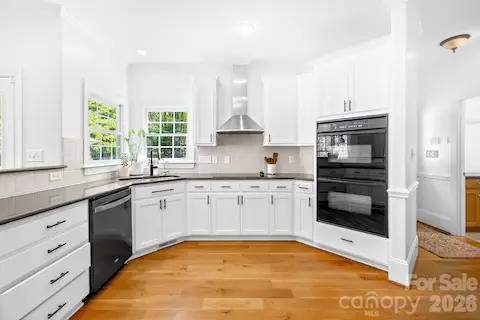 We love the dark granite countertops and white cabinets. Such a fresh look!