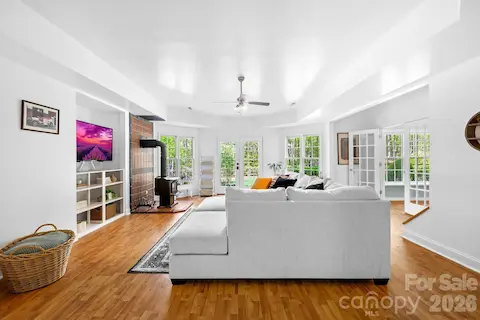 The basement has a living room with French doors leading to the backyard and features a wood burning stove.