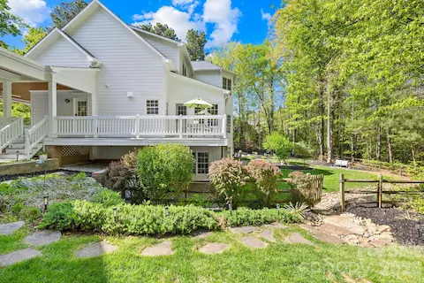 View of the side of the home and the fenced-in backyard.