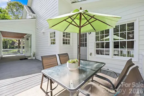 This decks connects to the wrap-around porch and is located just off the kitchen door and leads to the garage entry.