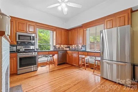 The classically updated kitchen offers high-quality wood cabinetry, granite countertops, and a design that honors the home’s history while supporting modern use.