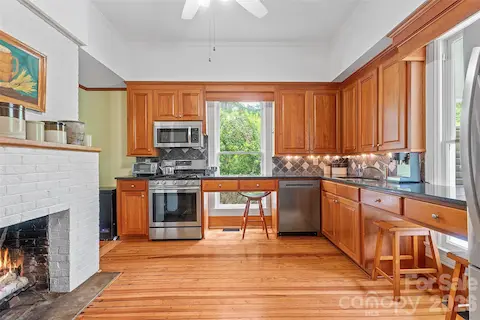The classically updated kitchen offers high-quality wood cabinetry, granite countertops, and a design that honors the home’s history while supporting modern use.