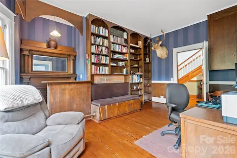 Study connected to primary bedroom with timeless woodworking and built in bench seat, bar and classic mantel.