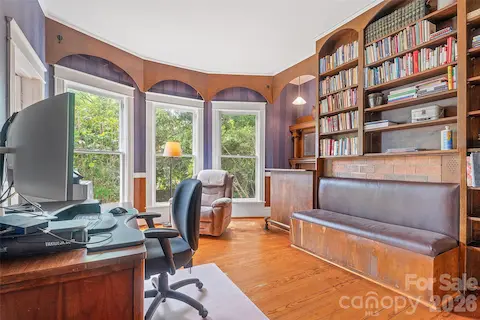 Study connected to primary bedroom with timeless woodworking and built in bench seat, bar and classic mantel.