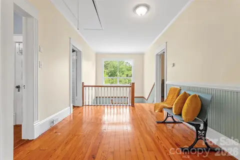 Traditional large landing with plent of light at top of the stairs and additional closets.