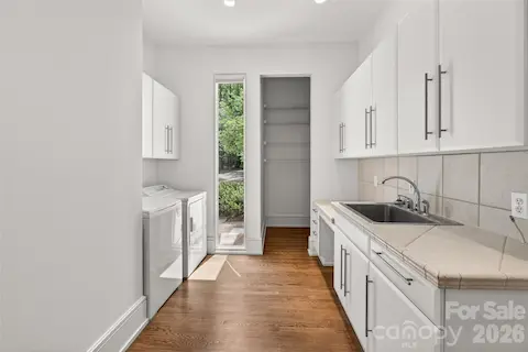 Large laundry room with sink and great storage.
