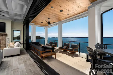 EXPERIENCE THE BEST IN LAKESIDE LIVING WHEN YOU STEP OVER THE THRESHOLD TO TAKE IN THE UNOBSTRUCTED PANORAMIC VIEWS FROM THIS GLASS-PANELED RAILING /COVERED PATIO,  WITH NATURAL WOOD TONGUE AND GROOVE CEILING, SLEEK MODERN CEILING FAN EFFORTLESSLY CREATES "RELAXATION"