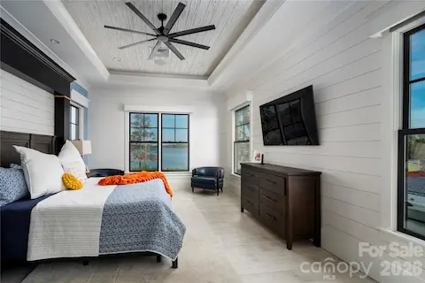 LUXURIOUS PRIMARY SUITE DESIGNED AS A PRIVATE SANCTUARY.  SPECTACULAR DEEP TRAY CEILING WITH CUSTOM AMBIENCE LIGHTING, COMBINES HIGH-END CRAFTSMANSHIP WITH THE SERENITY OF LAKE NORMAN