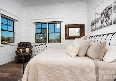 CHARMING  LIGHT FILLED GUEST BEDROOM HIGHLIGHTS BRIGHT SHIPLAP, HIGH CEILING, ALL WINDOWS HAVE AUTOMATIC SHADES AND AN EXQUISITE ENSUITE BATHROOM.