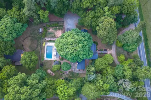 The tree canopy and landscaping provide a cool and private retreat around the home.