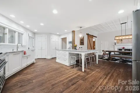 Newly renovated kitchen with honed marble countertops, inset custom cabinetry, top of the line appliances including an Italian Bertazonni Gas Range and matching exhaust hood