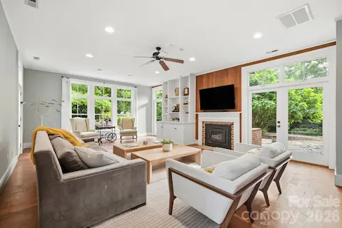Great room addition by previous owners offer wall of windows and glass doors, natural wood accent wall and built-in book cases and cabinets, separate H/A.
