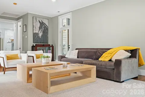 Great room has access to side courtyard and back patio areas.  Also offers a wet bar with a beverage refrigerator and porcelain farmhouse sink.
