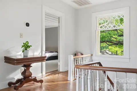 Large loft area with a sitting area at the opposite side from stairs.