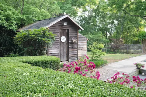 Original tack house used as storage and pool equipment.  Landscaping includes blueberry and blackberry bushes, fig and mulberry trees and several varieties of roses.