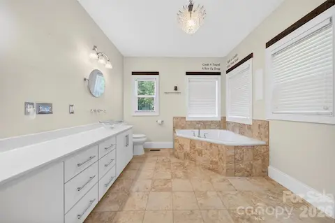 Primary En Suite bath features large corner soaking tub and a corner walk-in shower, dual vanity with vessel sinks and abundant storage.