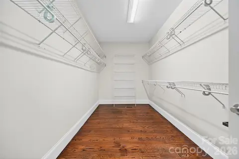 Huge walk-in closet for your Primary bedroom with wood floors