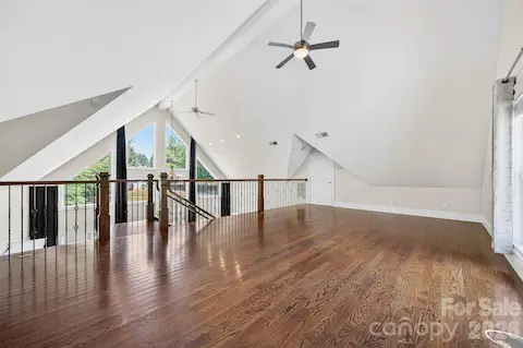 Huge upper loft features natural light and custom metal spindles